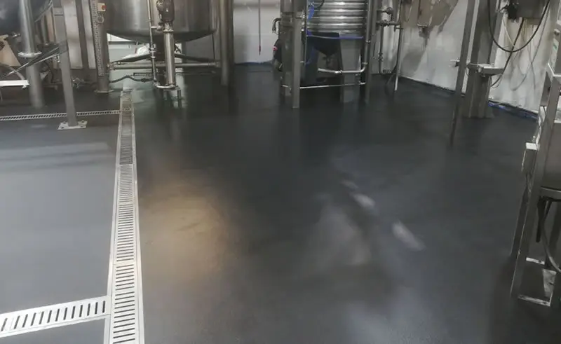 resin flooring completed in a health and beauty manufacturer in bradford Completed black resin floor with drainage