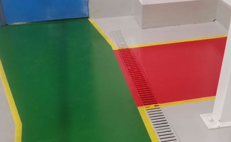 red and green pedestrian walkway installed in a factory